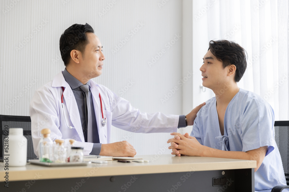 Professional doctor interacting consulting with young male patient at clinic, Male patient get advice about medicine from doctor at hospital Professional doctor interacting consulting with young male patient at clinic, Male patient get advice about medicine from doctor at hospital