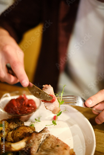 close-up, man's hands eating meat