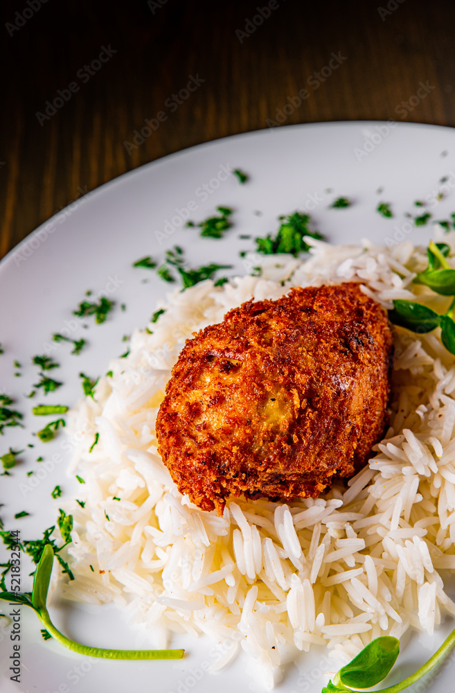 roasted burger with rice in white plate on wooden table background roasted burger with rice in white plate on wooden table background