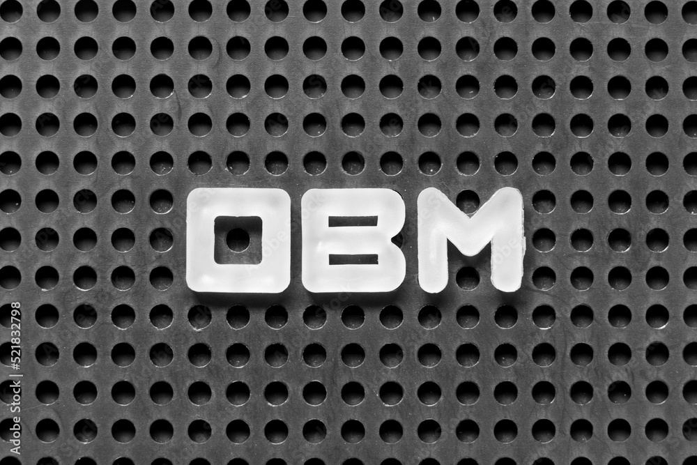 White alphabet letter in word OBM (Abbreviation of Original brand manufacturer) on black pegboard background
