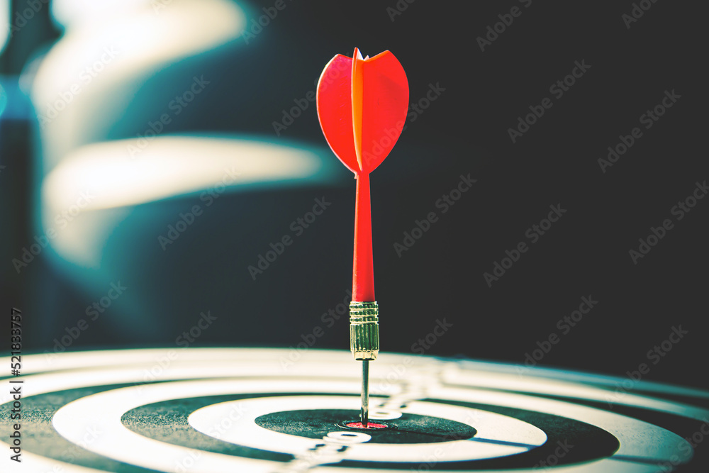 Bullseye or Bulls eye target or dartboard has dart arrow throw hitting the center of a shooting for financial business targeting planning and aim to winner goal of business concept. Bullseye or Bulls eye target or dartboard has dart arrow throw hitting the center of a shooting for financial business targeting planning and aim to winner goal of business concept.