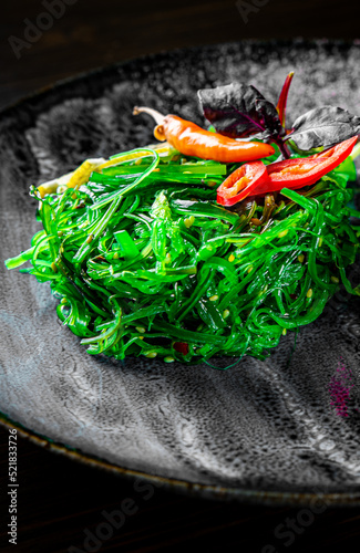 Chuka Seaweed Salad in plate on black wooden table background