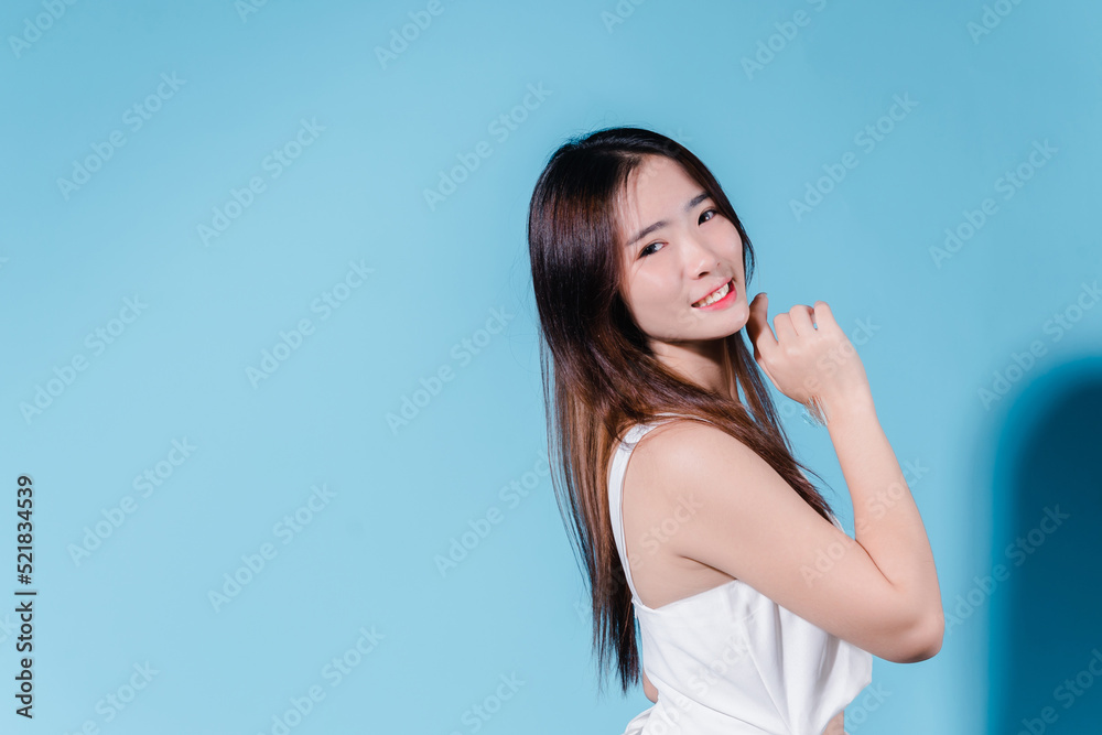 Charming asian beauty woman hold sun cream with sun protection uv or sunscreen on the blue background Charming asian beauty woman hold sun cream with sun protection uv or sunscreen on the blue background