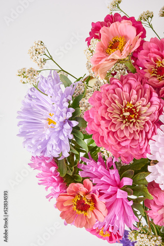 A bouquet of bright flowers on a light background.