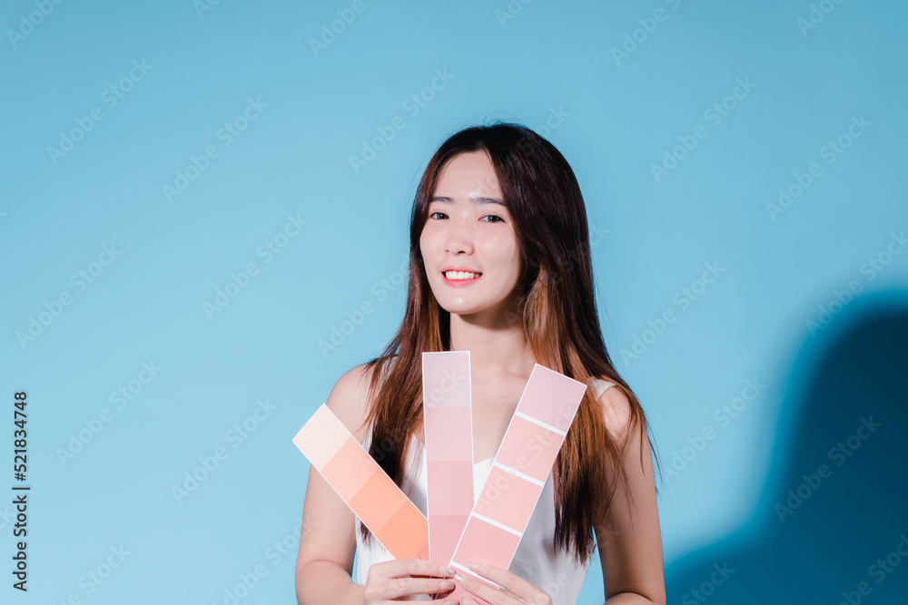 Charming asian beauty woman take color scale on the blue background Charming asian beauty woman take color scale on the blue background