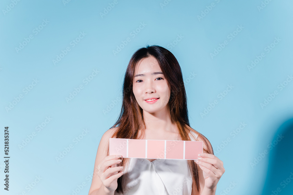 Charming asian beauty woman take color scale on the blue background Charming asian beauty woman take color scale on the blue background