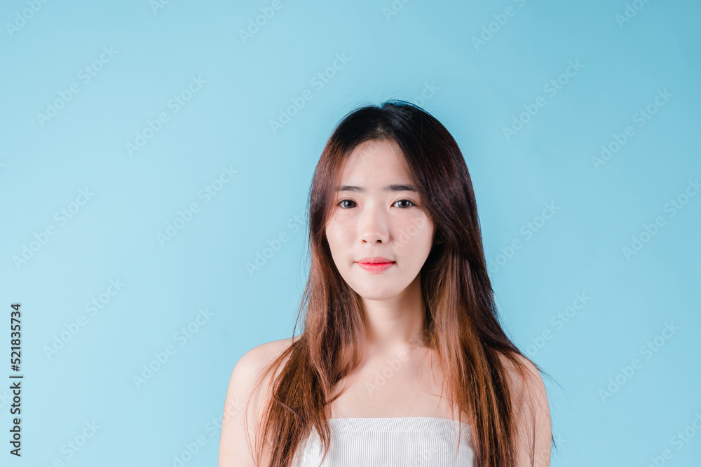 Charming portrait of Asian woman smiling confidence beauty make up on the blue background Charming portrait of Asian woman smiling confidence beauty make up on the blue background