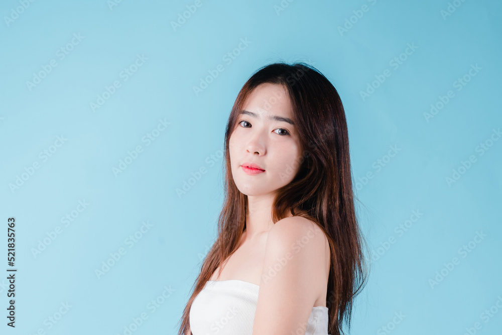 Charming portrait of Asian woman smiling confidence beauty make up on the blue background Charming portrait of Asian woman smiling confidence beauty make up on the blue background