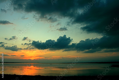 Sunset on the calm water of tha saline