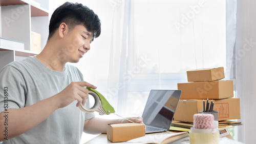 Man is packing in the mailbox to prepare to deliver it to the customer, Working at home and owning businesses, Online shopping SME entrepreneur, packing box, Sell online, freelance working.
