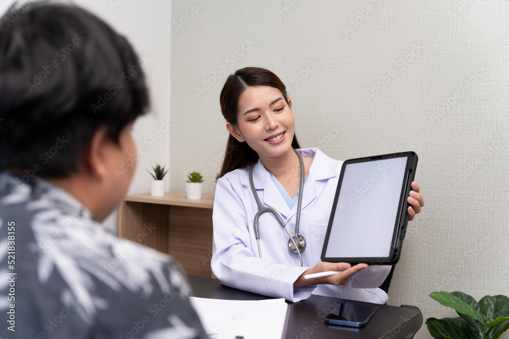 A beautiful Asian doctor discusses the condition of a male patient being hospitalized Check results in tablet A beautiful Asian doctor discusses the condition of a male patient being hospitalized Check results in tablet