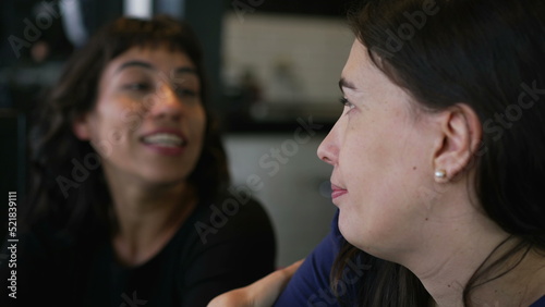 Female friends talking at restaurant chatting. Two women in conversation