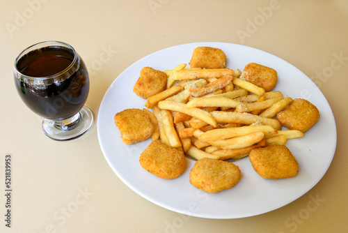 Fried Chicken breast hot crispy strips crunchy chicken tenders isolated on white background.Nuggets isolated on white background on a plate