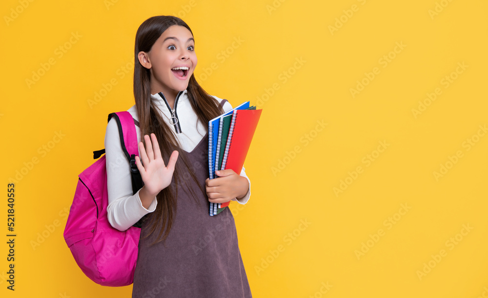 amazed child with school backpack and workbook on yellow background amazed child with school backpack and workbook on yellow background