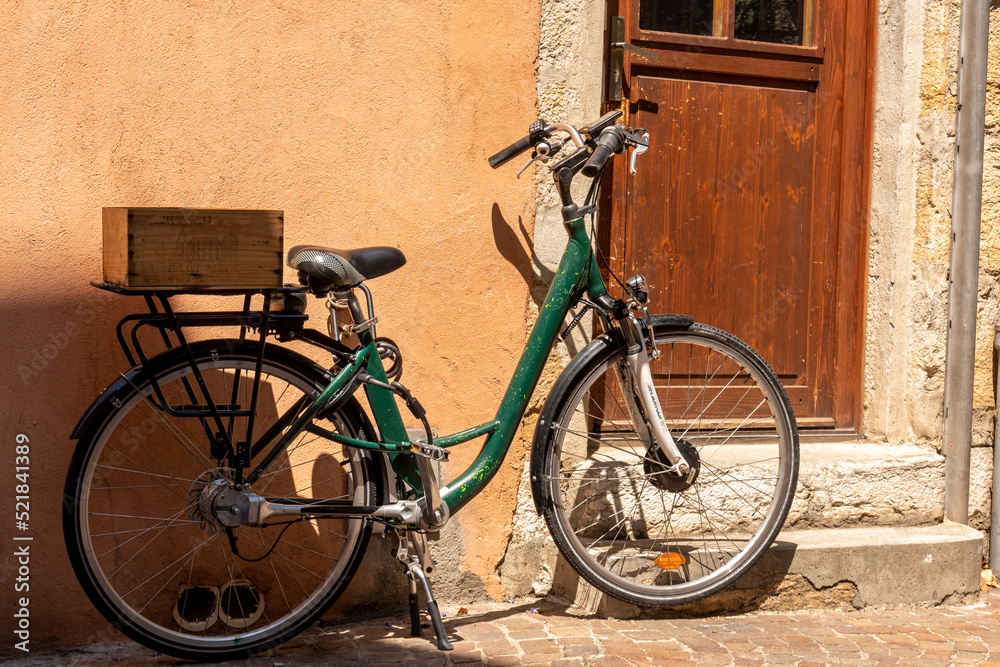 Bicycle parked by the door of a house in Annecy, France