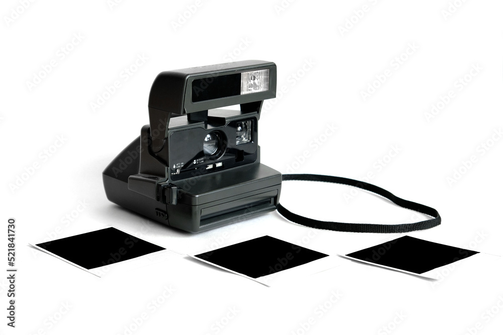 An old retro polaroid camera for instant photographing on a white background. An old retro polaroid camera for instant photographing on a white background.