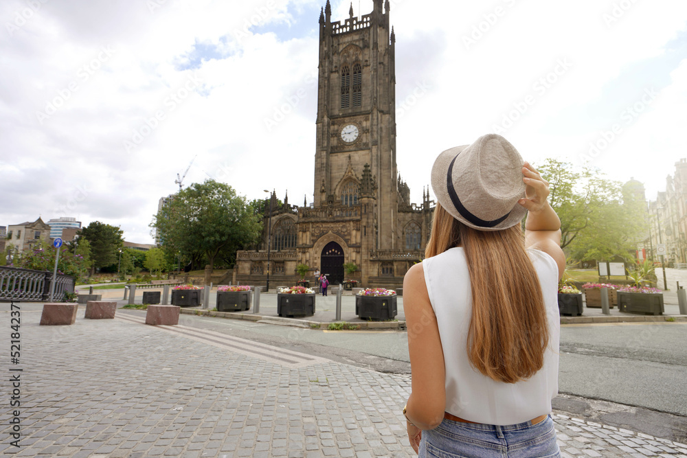 Tourism in UK. Back view of beautiful woman visiting in the city of Manchester, United Kingdom.