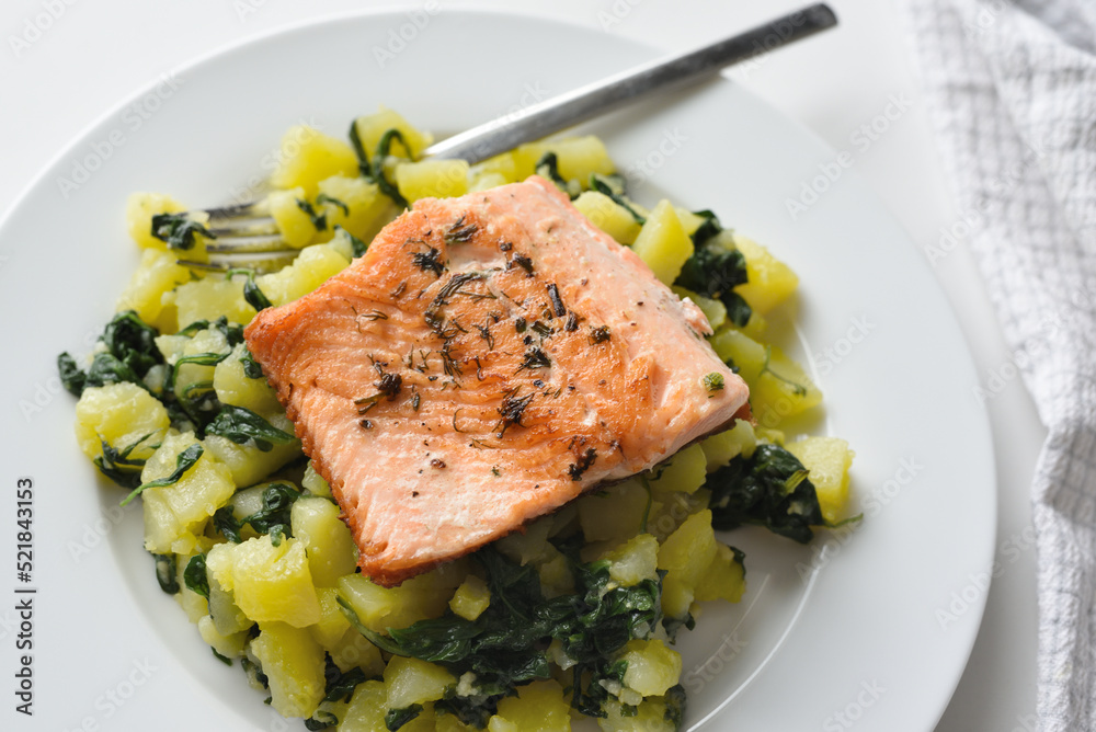 Fried trout served with potatoes and spinach Fried trout served with potatoes and spinach
