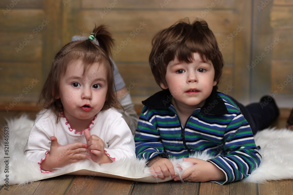 Little twins are lying on the floor Little twins are lying on the floor