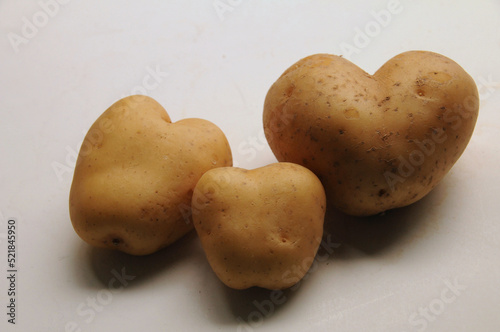 Three heart shaped potato tubers close together like a family