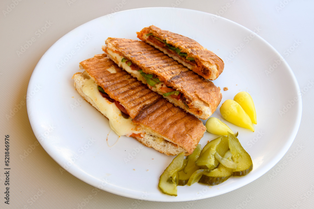Turkish karisik atom tost ( kasarli bazlama tost) . Flat baked bread toasted Turkish karisik atom tost ( kasarli bazlama tost) . Flat baked bread toasted