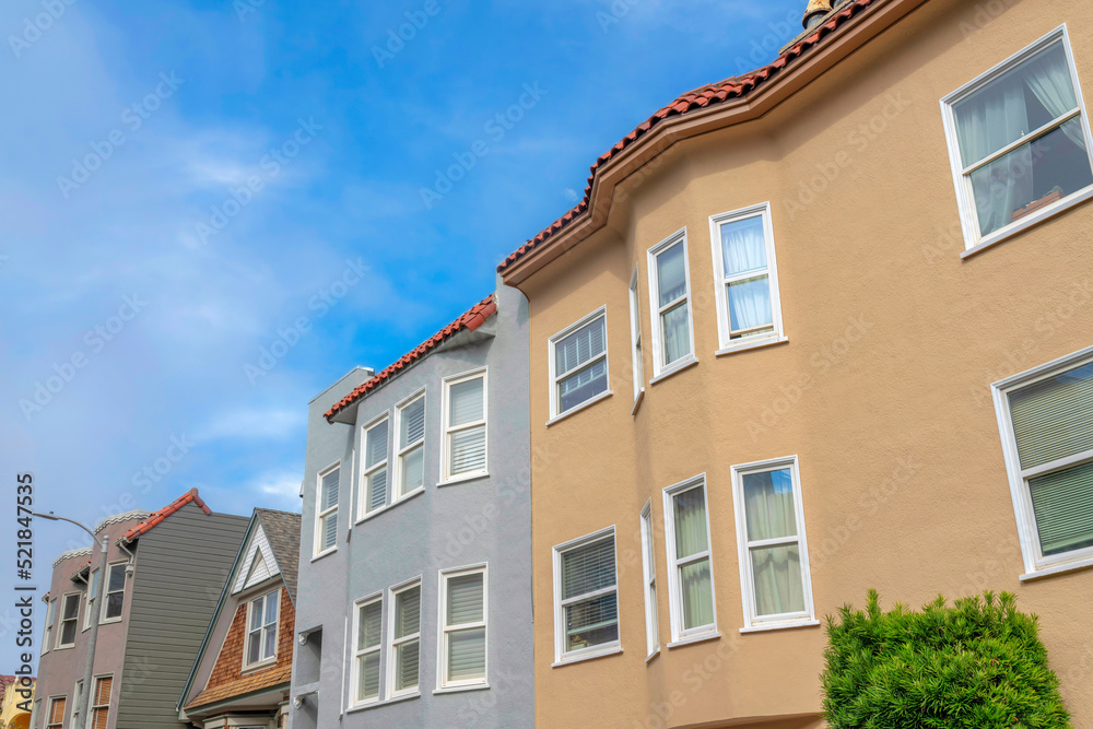 Row of townhouses and single-family home in a low angle view in San Francisco, California