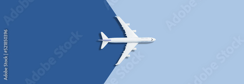 Flat lay of miniature toy airplane on blue background