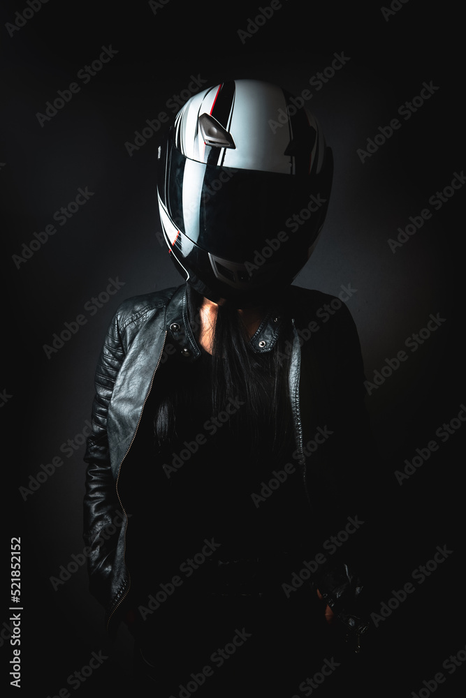 a woman stands in a helmet from a motorcycle a woman stands in a helmet from a motorcycle