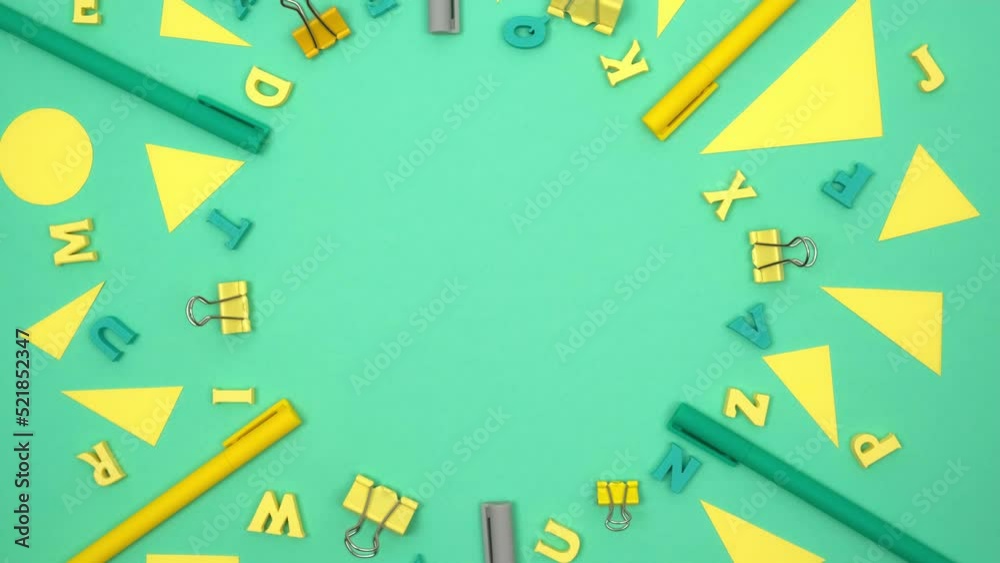 rotating frame made of various yellow, green stationery and educational supplies on a light green background, flat, with space for text. back to school. top view. 4k. rotating frame made of various yellow, green stationery and educational supplies on a light green background, flat, with space for text. back to school. top view. 4k.
