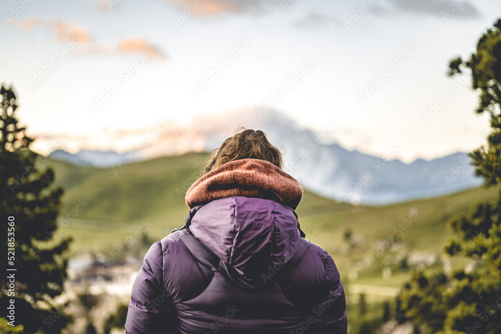 A woman is enjoying the sunrise in the Dolomites