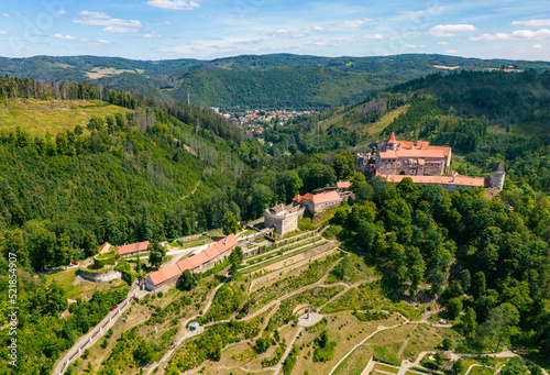 Aerial drone fly near the Pernstejn castle, Czech Republic. Vysocina region near the Nedvedice village. Summer day with sun and blue sky. Green nature and fresh forest. photo