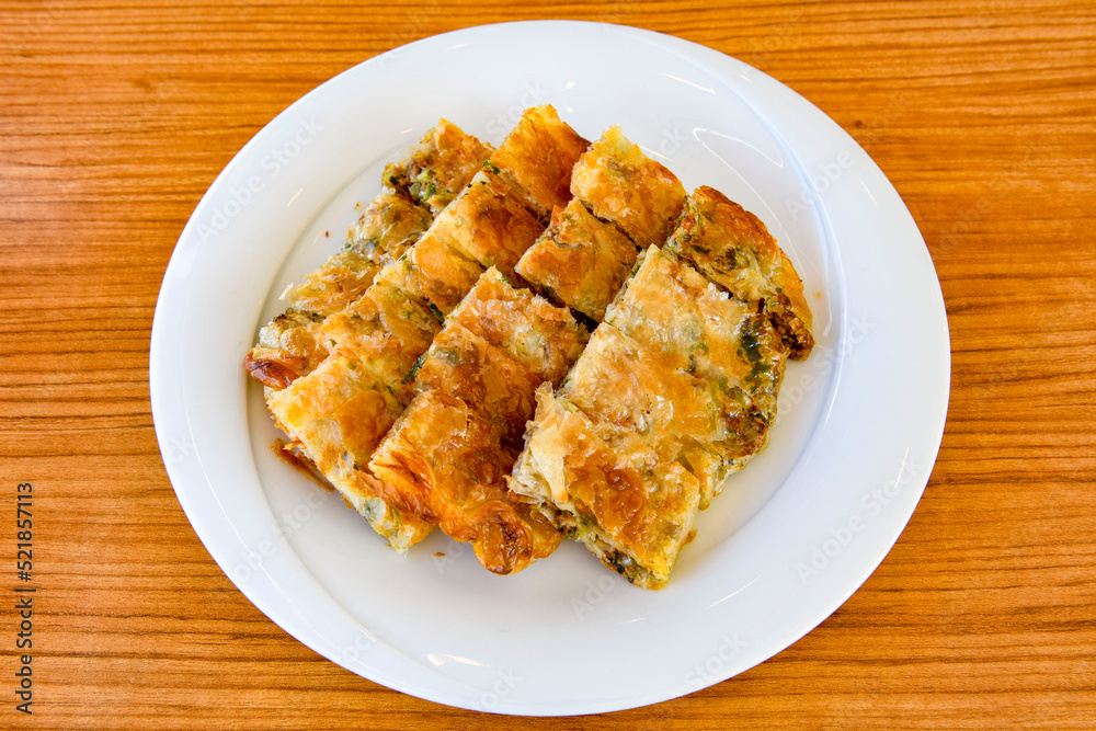 Homemade burek (borek) with cheese and spinach and boiled egg.Traditional food. Peynirli, Patatesli, kiymali kol boregi. Homemade burek (borek) with cheese and spinach and boiled egg.Traditional food. Peynirli, Patatesli, kiymali kol boregi.