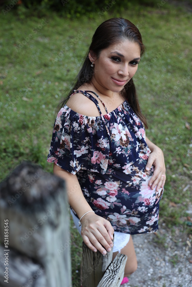 Miami, Florida / United States – December 31, 2021: Maternity Photoshoot in a Park - grass background Miami, Florida / United States – December 31, 2021: Maternity Photoshoot in a Park - grass background
