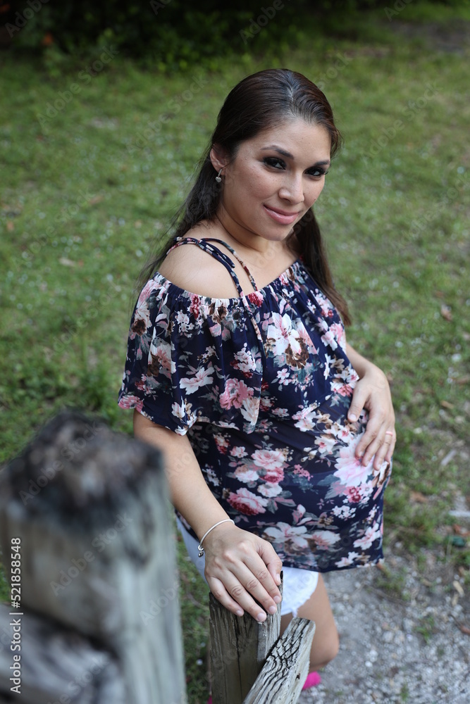 Miami, Florida / United States – December 31, 2021: Maternity Photoshoot in a Park - grass background Miami, Florida / United States – December 31, 2021: Maternity Photoshoot in a Park - grass background