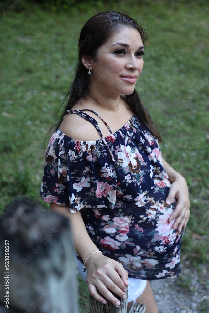 Miami, Florida / United States – December 31, 2021: Maternity Photoshoot in a Park - grass background Miami, Florida / United States – December 31, 2021: Maternity Photoshoot in a Park - grass background