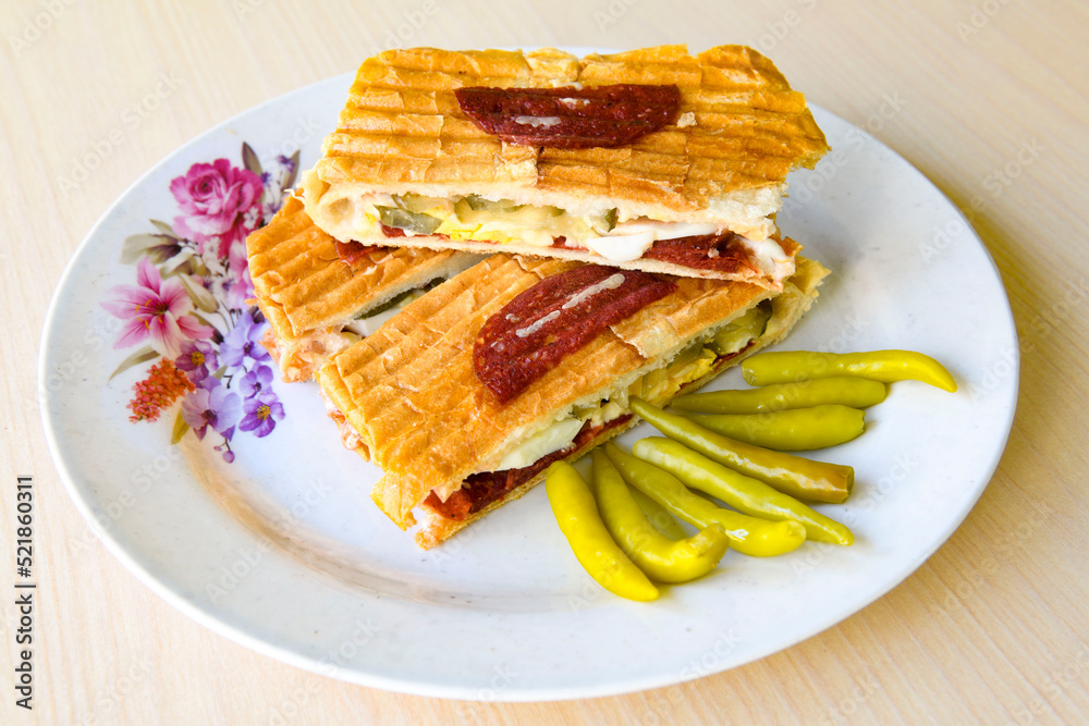 Turkish karisik atom tost ( kasarli bazlama tost) . Flat baked bread toasted Turkish karisik atom tost ( kasarli bazlama tost) . Flat baked bread toasted