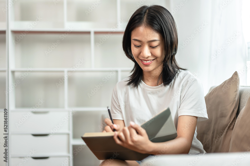 Half-Japanese woman is writing a diary on the sofa in her living room, Daily routine record, Relaxing time on vacation, Happy time, Living at home, Comfortable corner Half-Japanese woman is writing a diary on the sofa in her living room, Daily routine record, Relaxing time on vacation, Happy time, Living at home, Comfortable corner