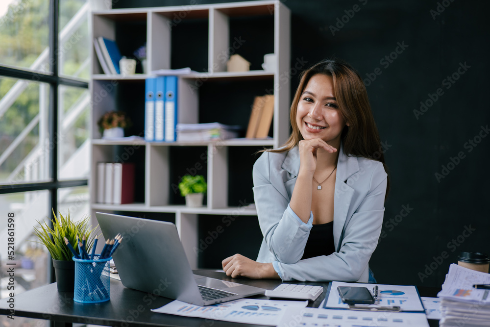 Young business women working on laptop with happy and smile face on office spec.