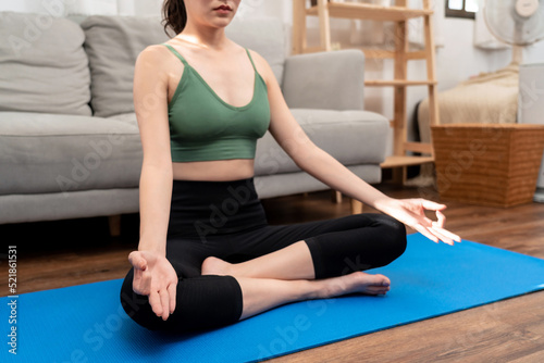 Young woman is relaxing into the on couch before workout yoga exercise in her living room at home