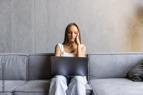 Slika na platnu Frustrated sad woman feeling tired worried about problem sitting on sofa with la