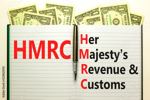 HMRC her majestys revenue and customs symbol. Concept words HMRC her majestys revenue and customs on white note on beautiful dollar background. Business HMRC revenue and customs concept. Copy space. photo