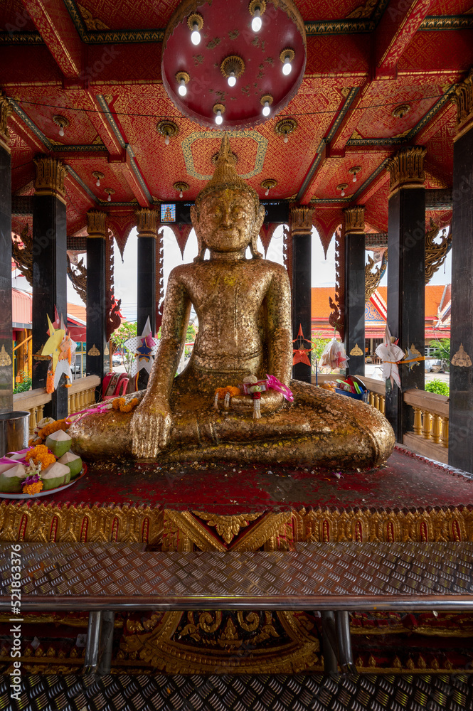 Fototapeta premium Samut Sakhon, Thailand - July 31, 2022. Wat Lak Si Rat Samoson A Buddhist temple famous for the reclining Buddha and also the other statue surrounded by imitated rocks.