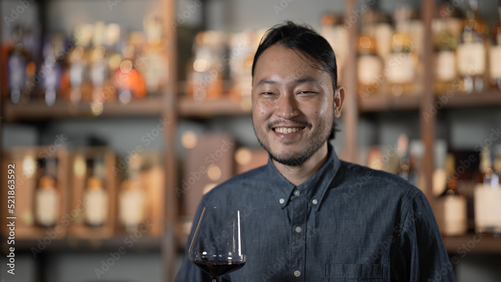 Fototapeta premium Night club concept of 4k Resolution. Asian man tasting wine in a restaurant. A group of specialized clubs that sell alcoholic beverages.