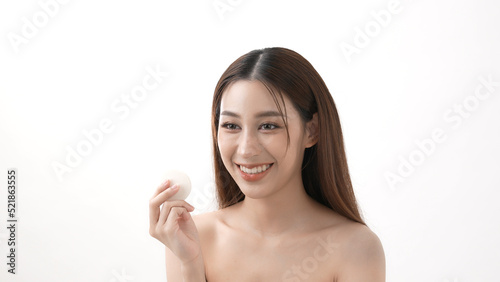 Beauty concept of 4k Resolution. Asian girls rub their cheeks with powder foundation.