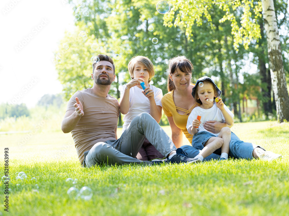 Happy family blowing soap bubbles