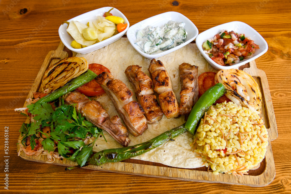 Beef steak grill with rice pilaf, fried potatoes, grilled pepper and tomatoes.Mix Platter with Beef rips, Cutlets, Potatoes and Sauces. Beef steak grill with rice pilaf, fried potatoes, grilled pepper and tomatoes.Mix Platter with Beef rips, Cutlets, Potatoes and Sauces.