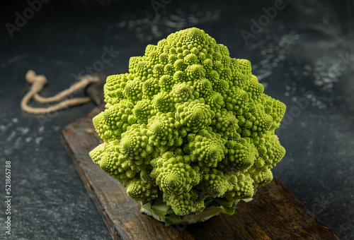 Romanesco broccoli head on a dark stone surface, cabbage, close up, fibonacci sequence, for those who love mathematics photo