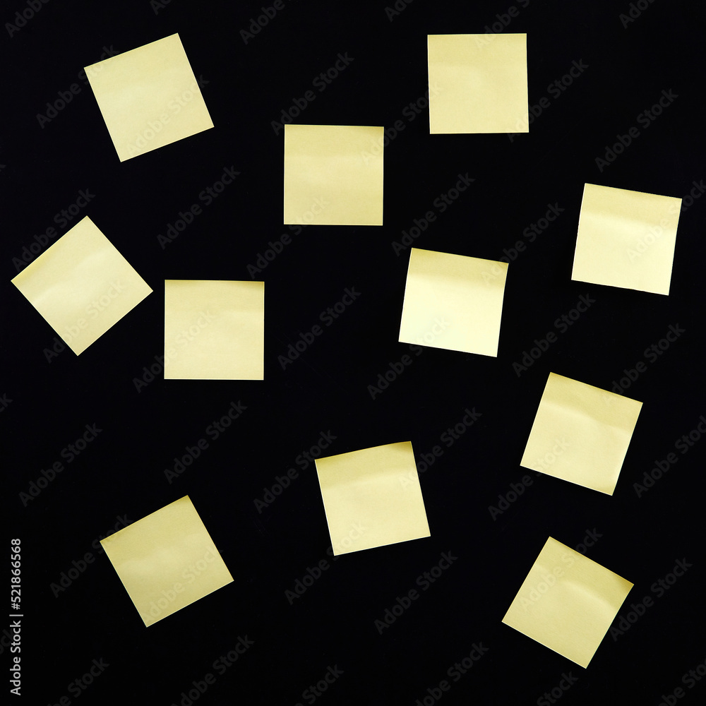 Blank yellow paper sticker notes on dark background Blank yellow paper sticker notes on dark background