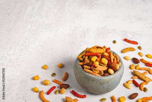 Spicy BBQ trail mix in a bowl on a light and airy background wit