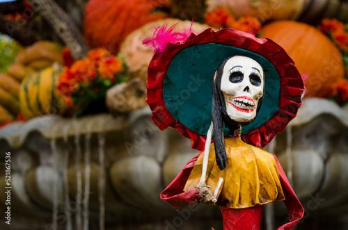 Dia de los Muertos skeleton statuette with fall background